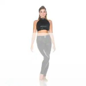 Smiling woman wearing black crop top and shiny leggings