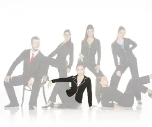 Six models pose in black suits with colorful piping.