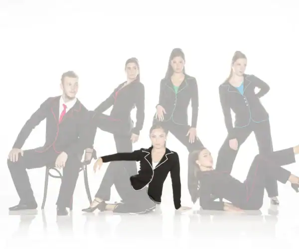 Six models pose in black suits with colorful piping.