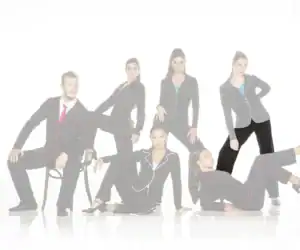 Six models pose in black suits with colorful piping.