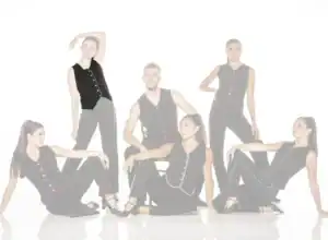 Six models wear black outfits with colorful piping.
