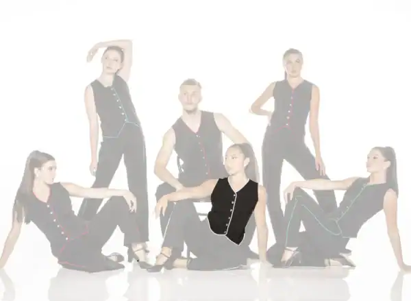 Five models pose in black outfits with colorful trim.