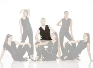 Six models wearing black outfits with colorful piping
