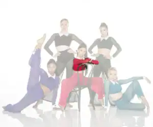 Five dancers pose in colorful costumes against a white background.