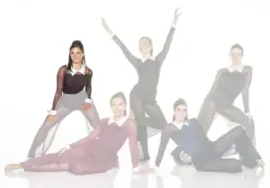 Five dancers posing in sheer black costumes against white background