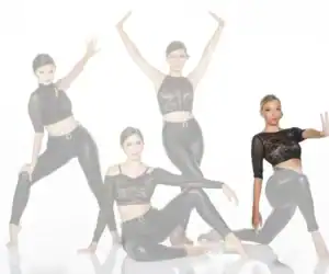 Four women in black lace tops and leggings posing