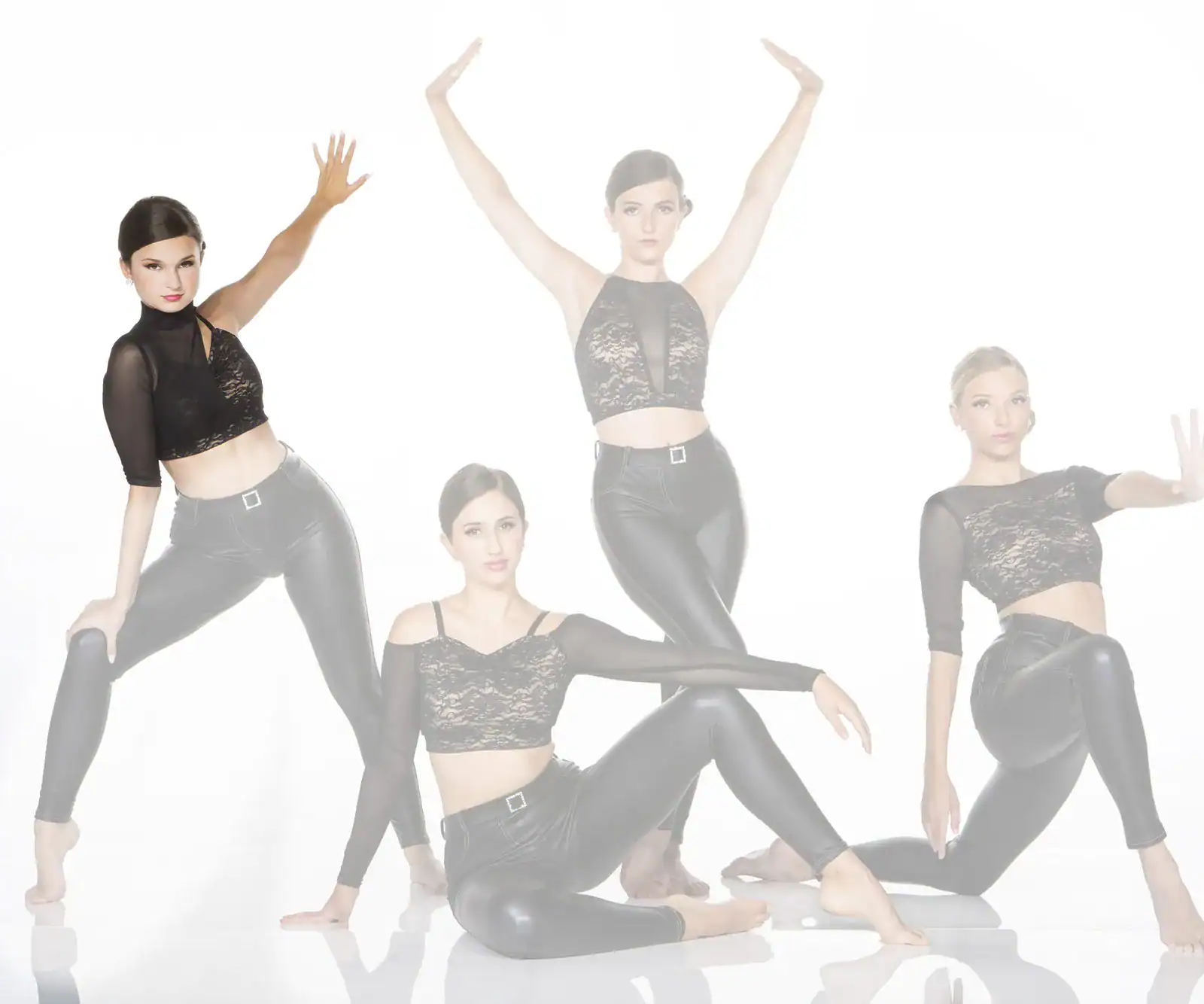 Four women in black outfits posing against white background
