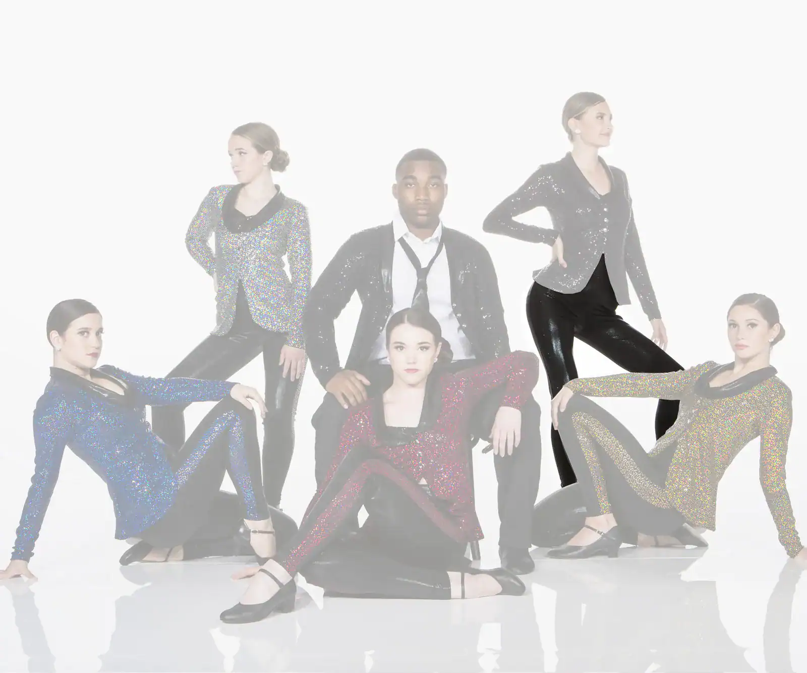 Five dancers pose in sparkling costumes against a white background.