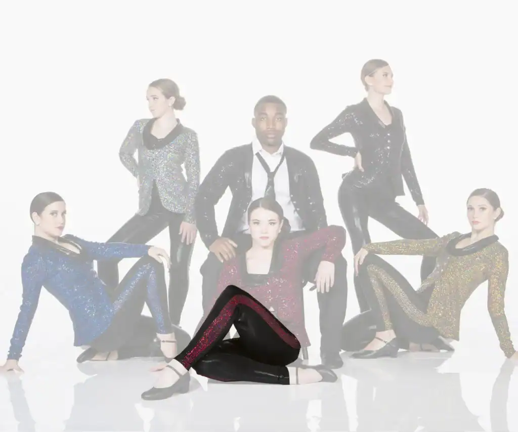 Six dancers pose in sparkling costumes against white background.