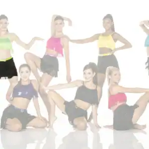 Seven dancers pose in colorful fringe costumes against white background.