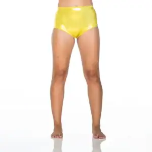 Model wearing shiny yellow high-waisted shorts