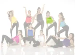 Nine young dancers pose in colorful fringe tops and black leggings.