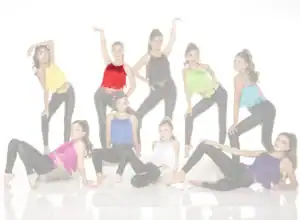 Nine young dancers posing in colorful fringe tops