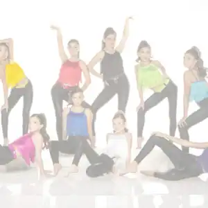 Nine young dancers pose in colorful fringe tops and black leggings.