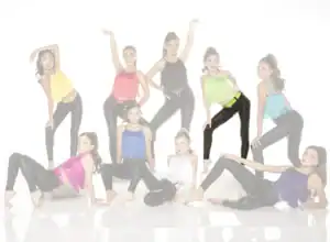 Young dancers posing in colorful fringe tops and black leggings