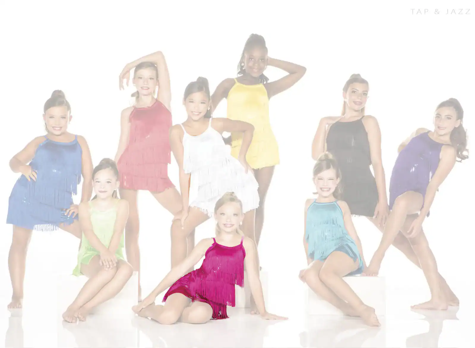 Young dancers in colorful fringe costumes posing in studio