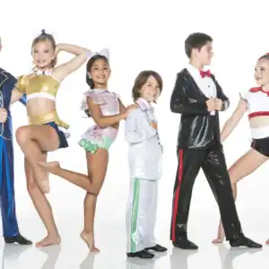 Six young dancers pose in colorful costumes against white background.