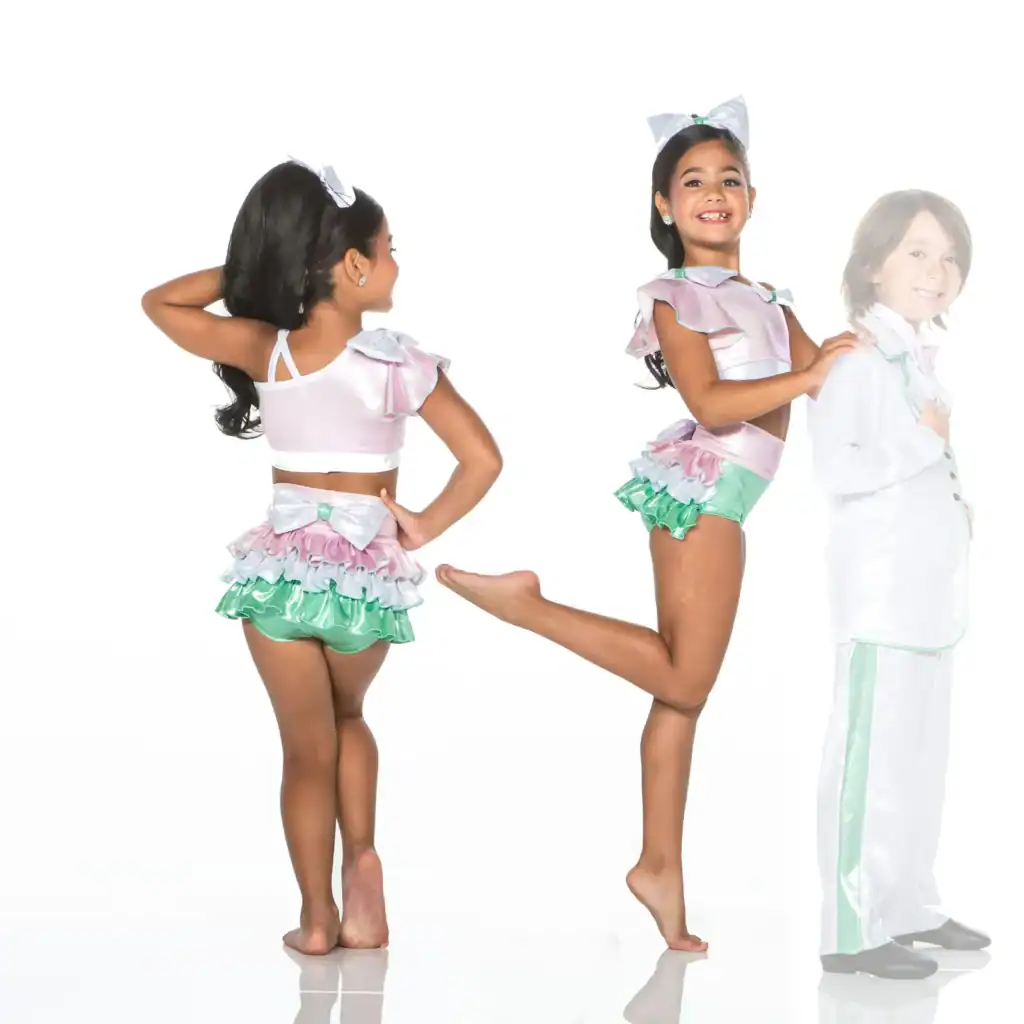 Girl in colorful costume posing beside faded boy