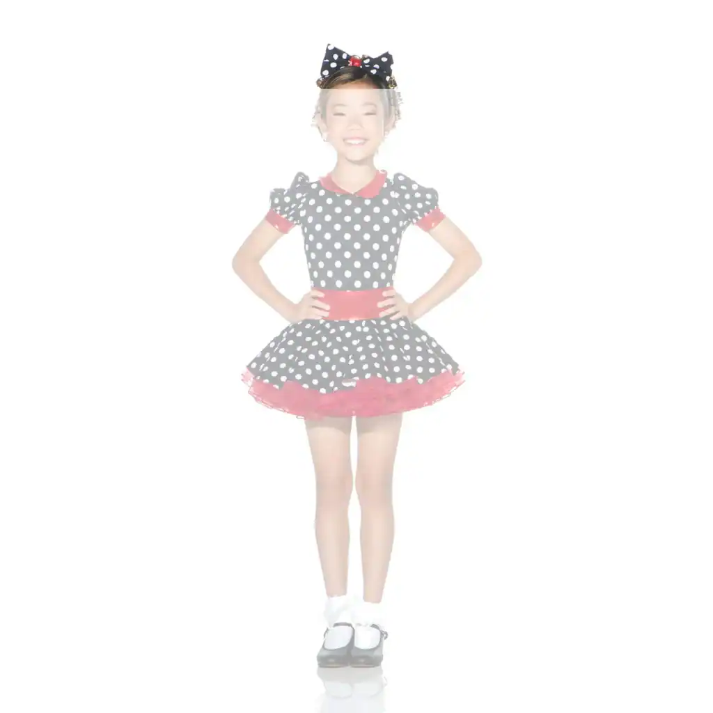 Smiling girl wearing a black polka-dot dress and bow