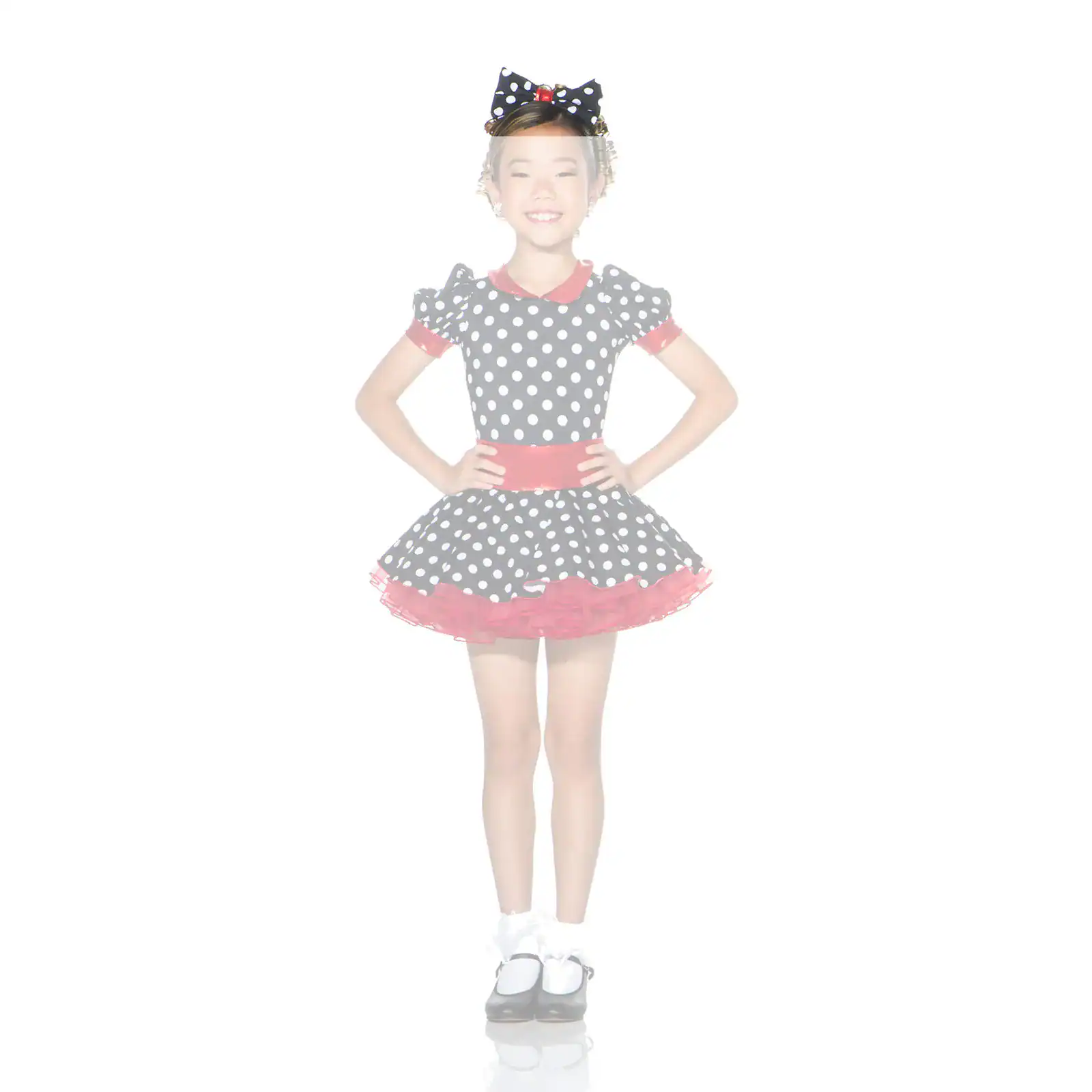 Smiling girl wearing a black polka-dot dress and bow