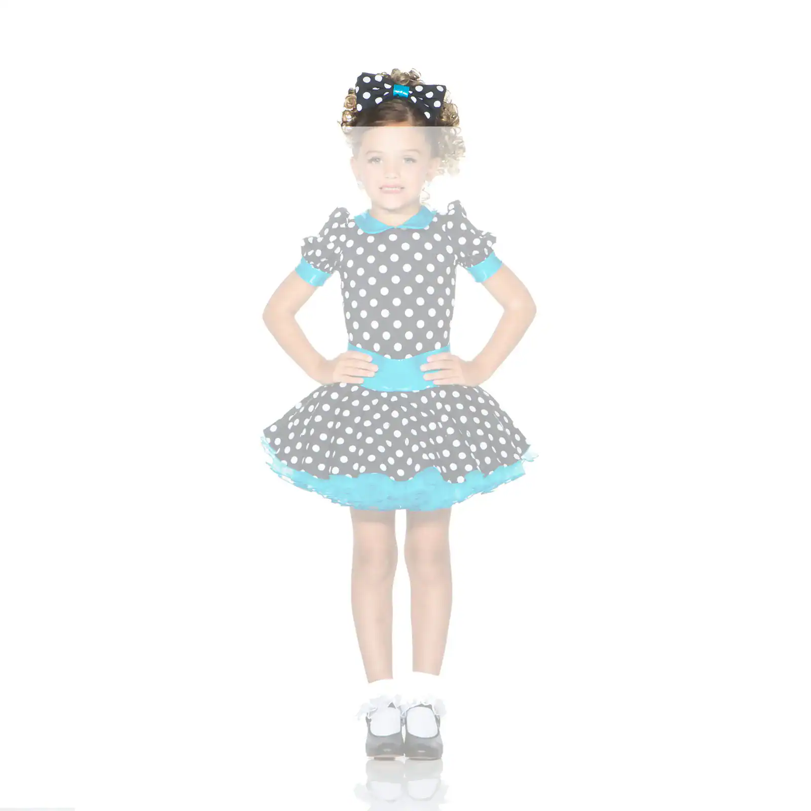Girl wearing black polka-dot dress with turquoise accents