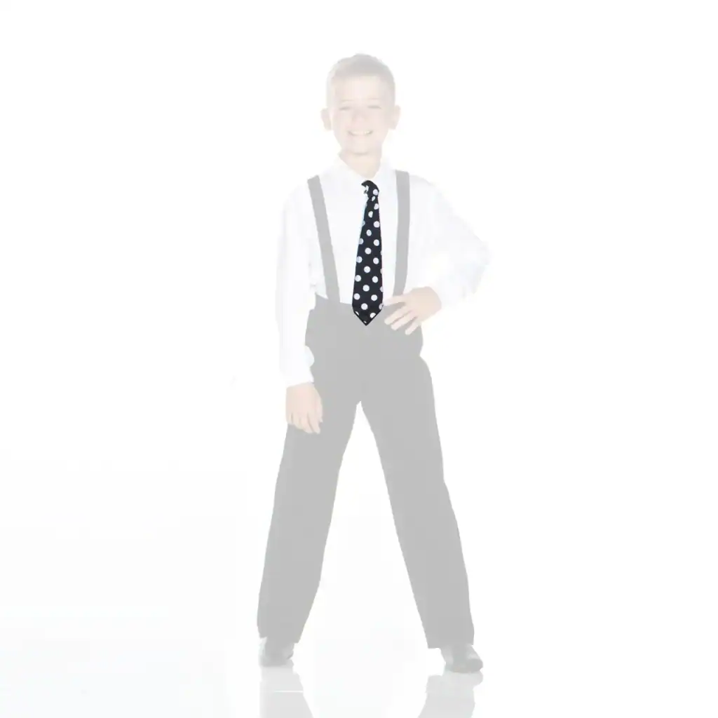 Smiling boy in suspenders wearing a black polka-dot tie