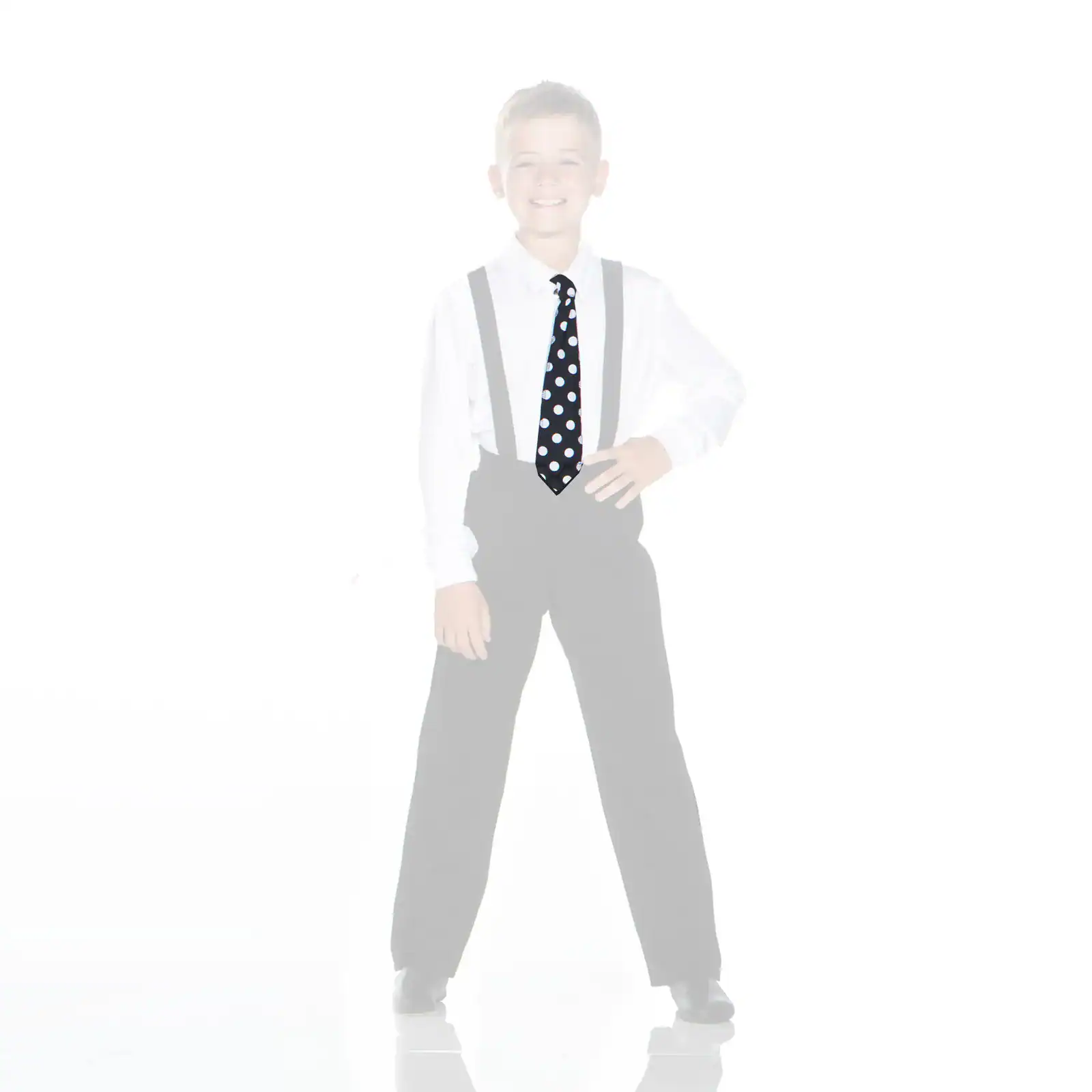 Smiling boy in suspenders wearing a black polka-dot tie