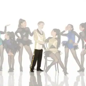 Young dancers pose in colorful costumes against white background.