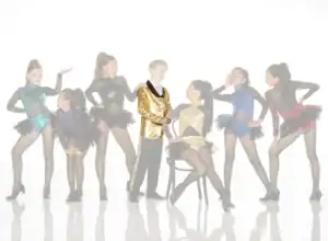 Young dancers pose in colorful costumes around boy in gold jacket