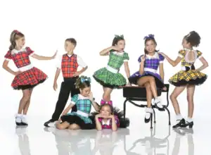 Children posing in colorful plaid dance costumes