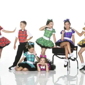 Children posing in colorful plaid dance costumes