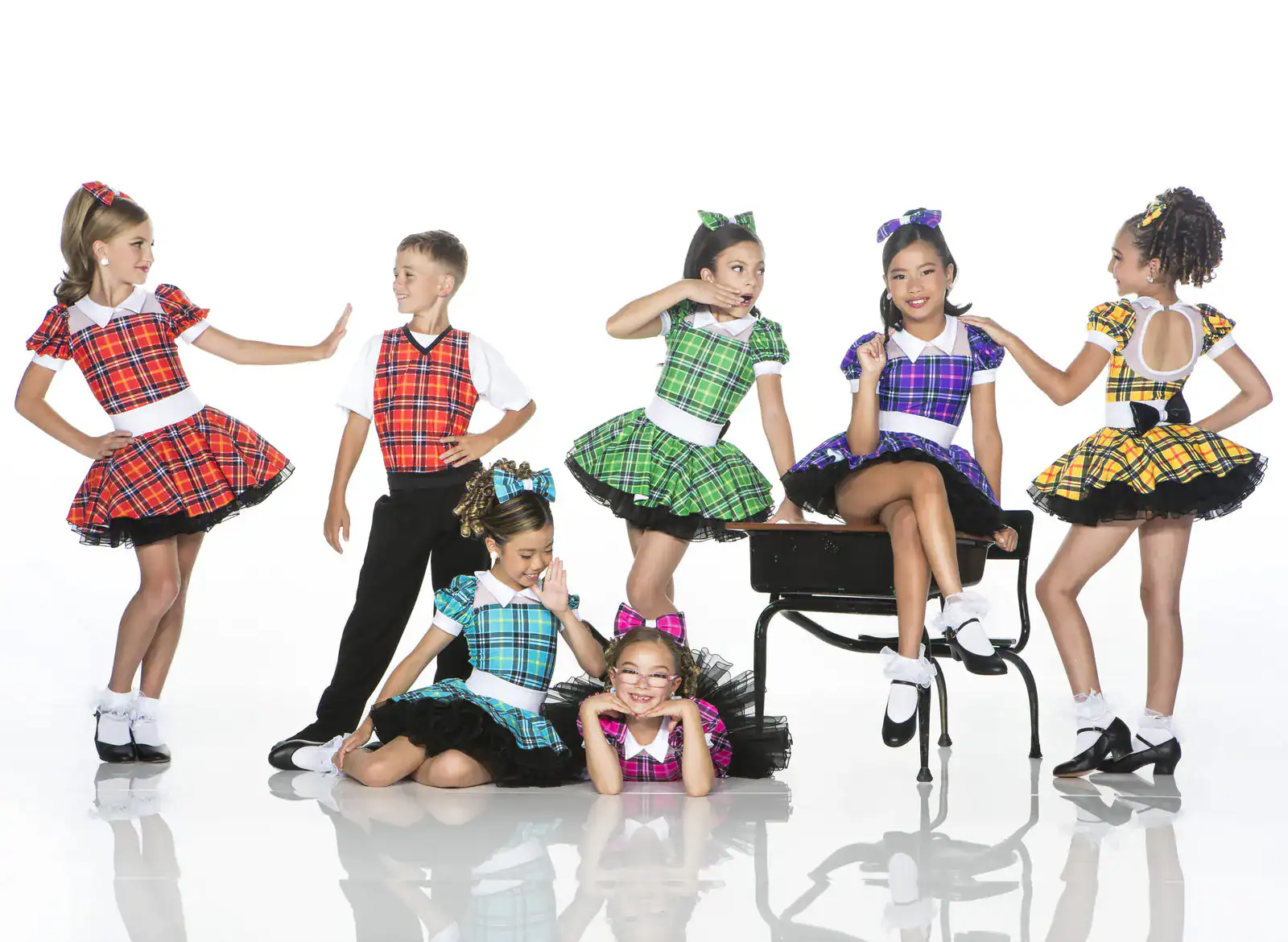 Children posing in colorful plaid dance costumes