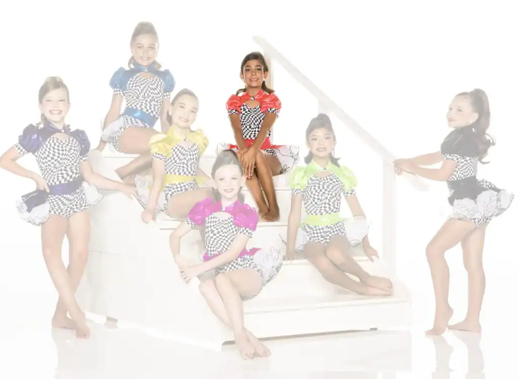 Seven young dancers in colorful checkered costumes pose on stairs.