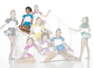 Young dancers in colorful costumes posing on white stairs