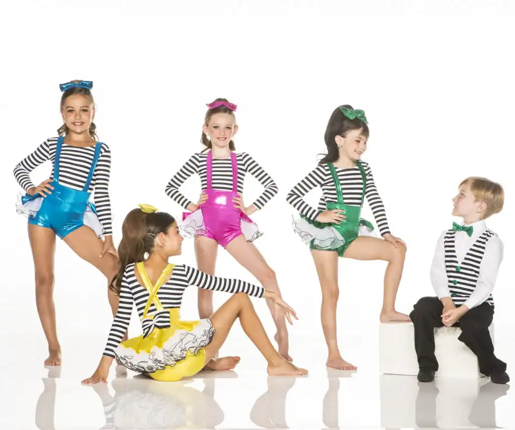 Five children wearing colorful striped dance costumes in studio