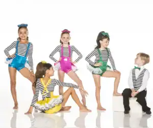 Five children wearing colorful striped dance costumes in studio