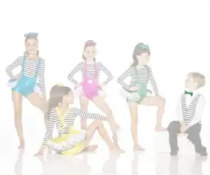 Five children in colorful striped dance costumes posing together