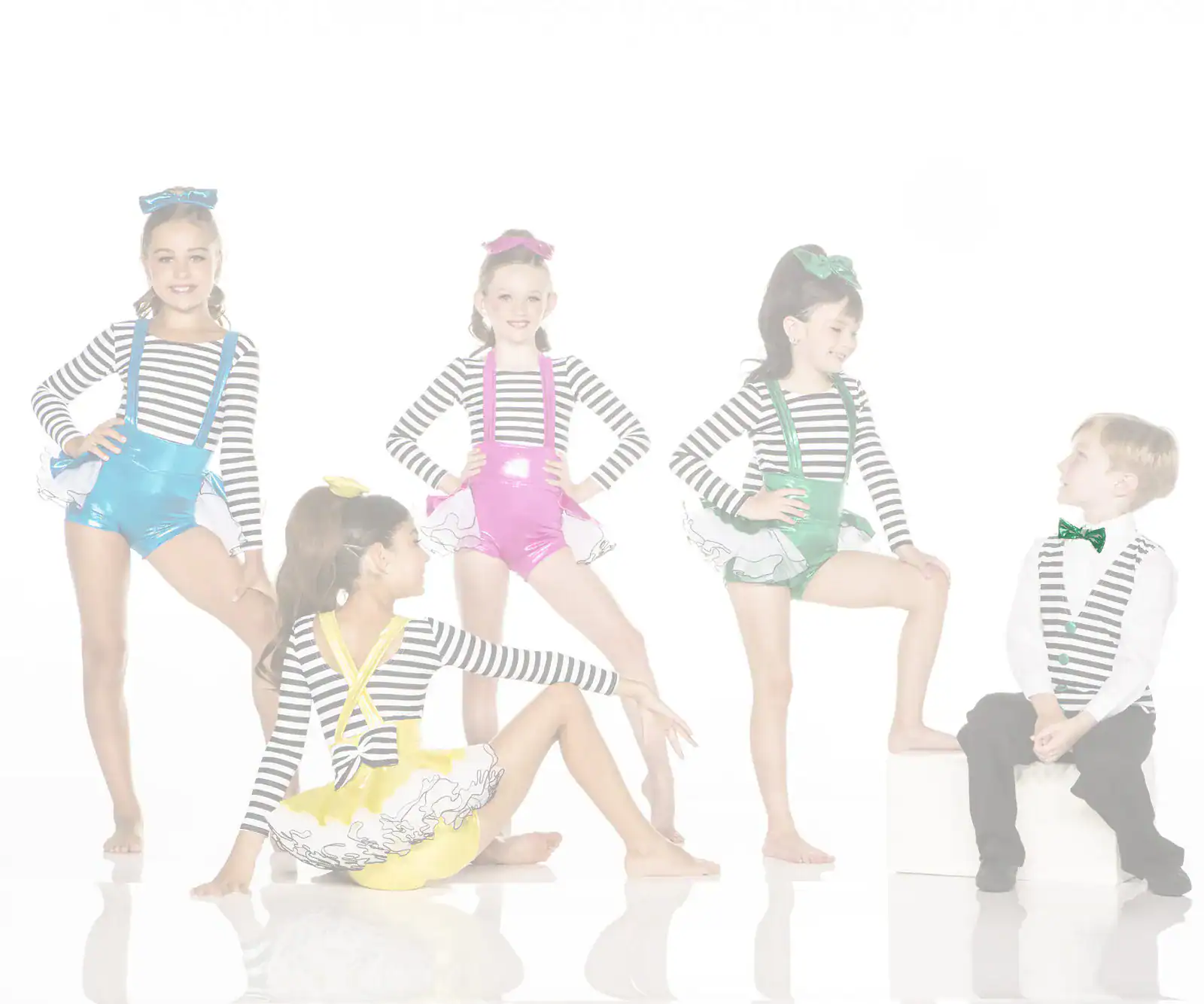 Five children in colorful striped dance costumes posing together