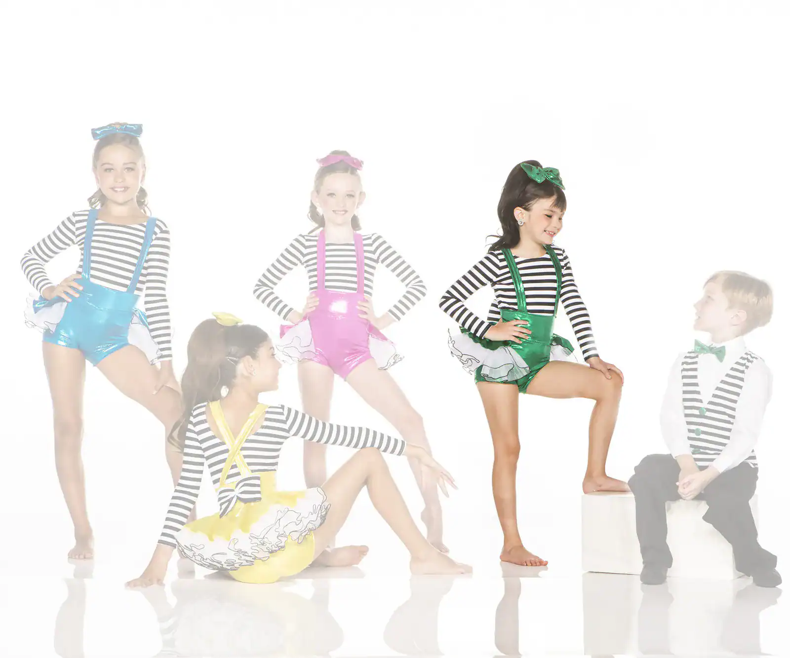 Five children wearing colorful striped dance costumes pose together
