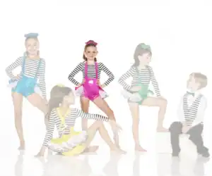 Young dancers in colorful costumes pose against white background.