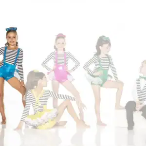 Five children wearing colorful striped dance costumes posing together