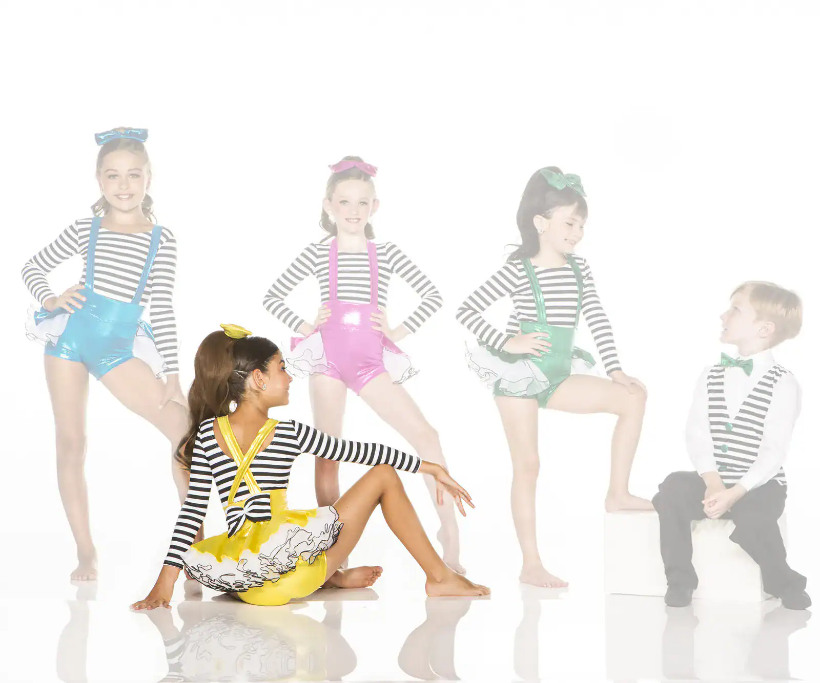 Five children in colorful striped dance costumes posing