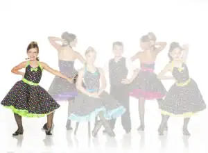 Children wearing colorful polka-dot dance costumes