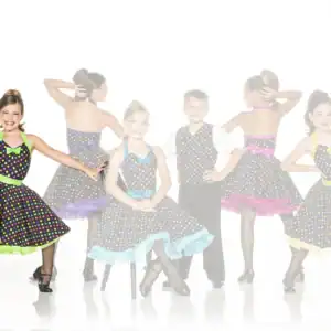 Children wearing colorful polka-dot dance costumes