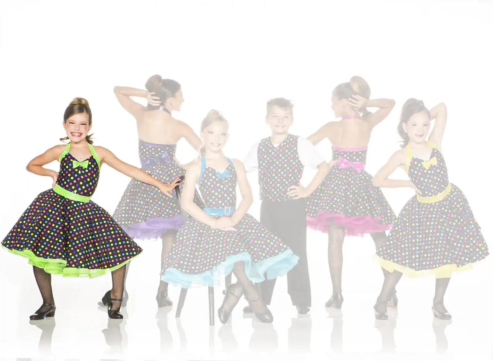 Children wearing colorful polka-dot dance costumes