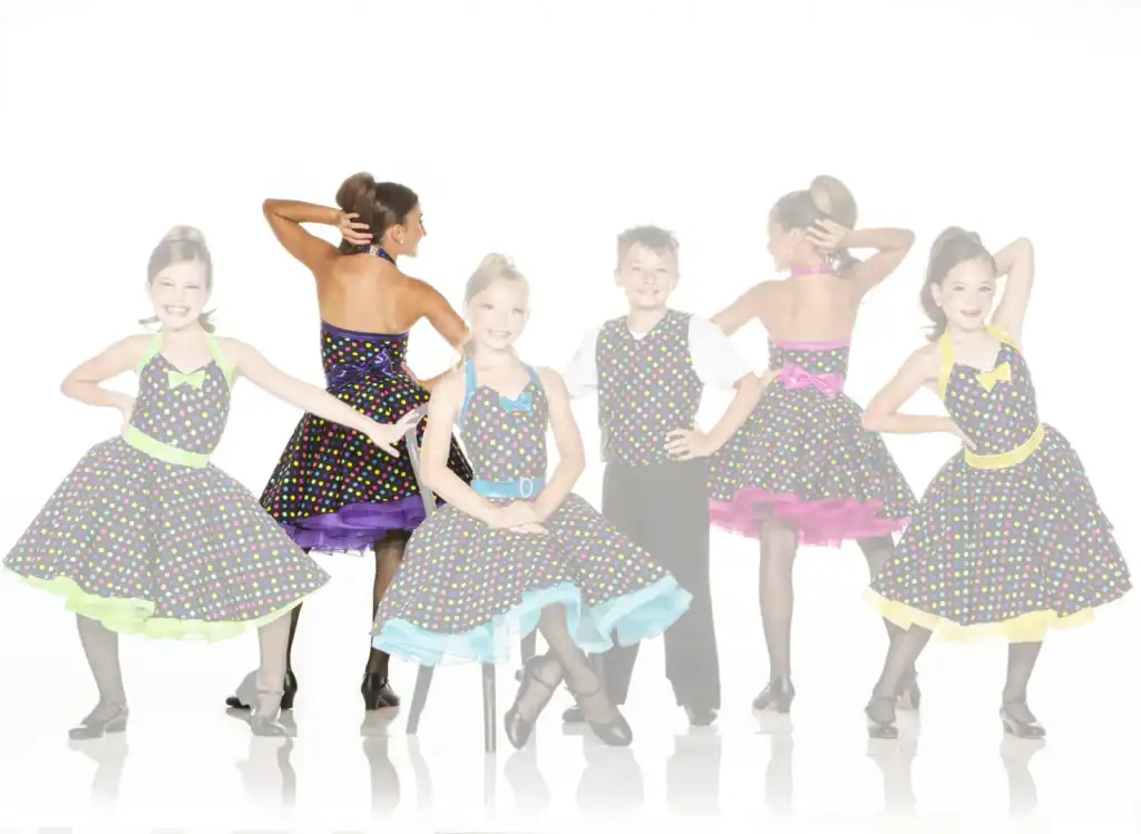 Children in colorful polka-dot dance costumes posing together