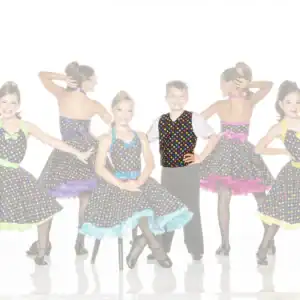 Five children pose in colorful polka-dot dance costumes.