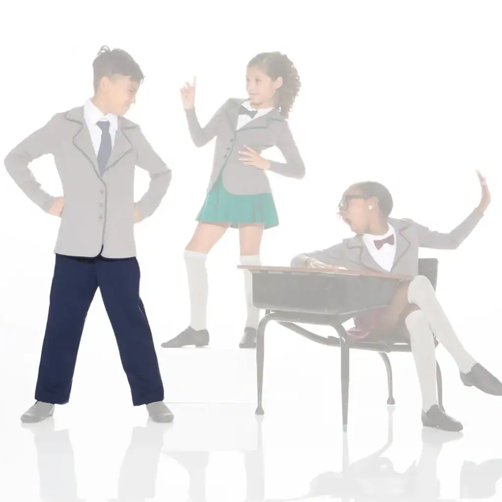Three students in uniforms pose around a school desk.