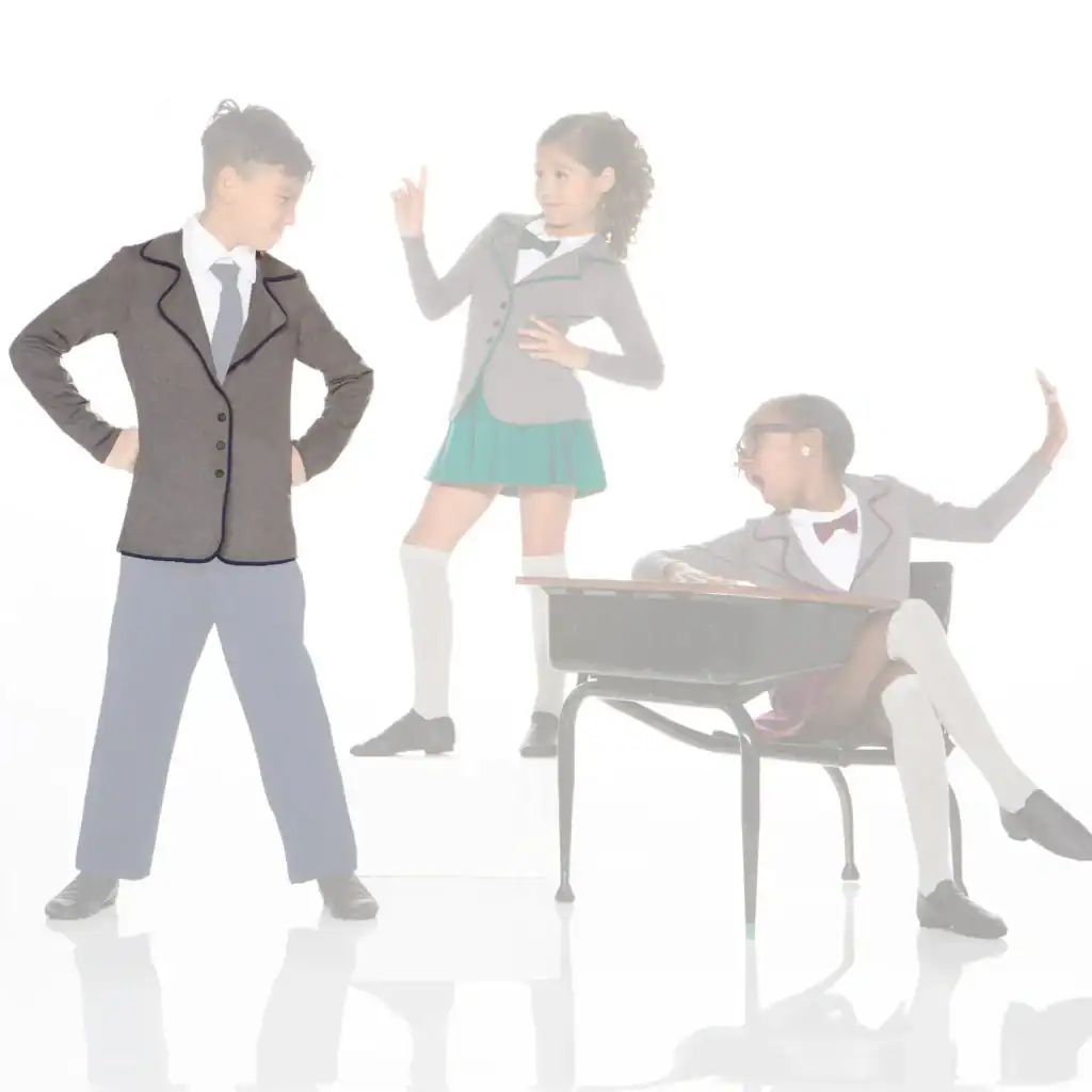 Three children in school uniforms posing around a classroom desk.