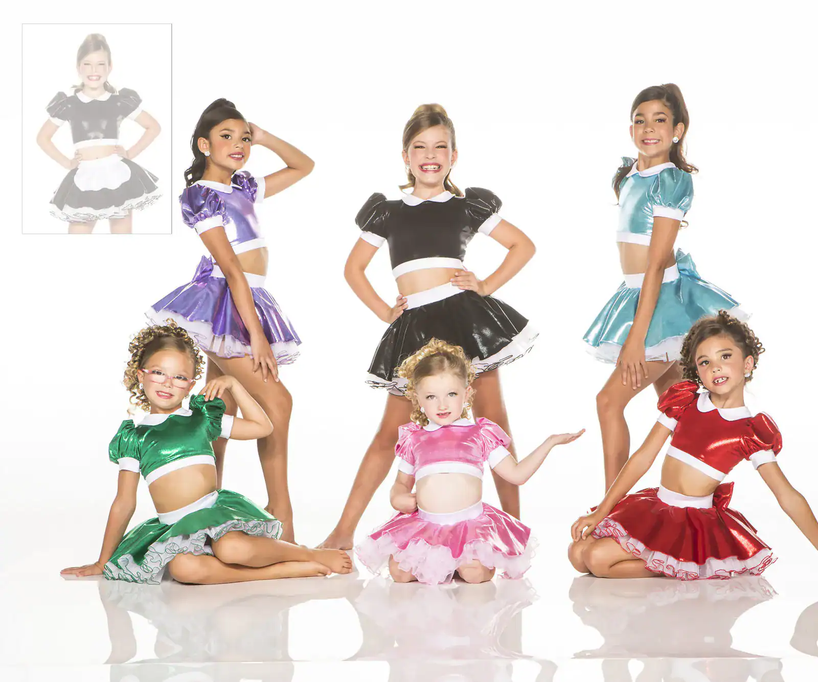 Girls modeling colorful shiny dance costumes on white background